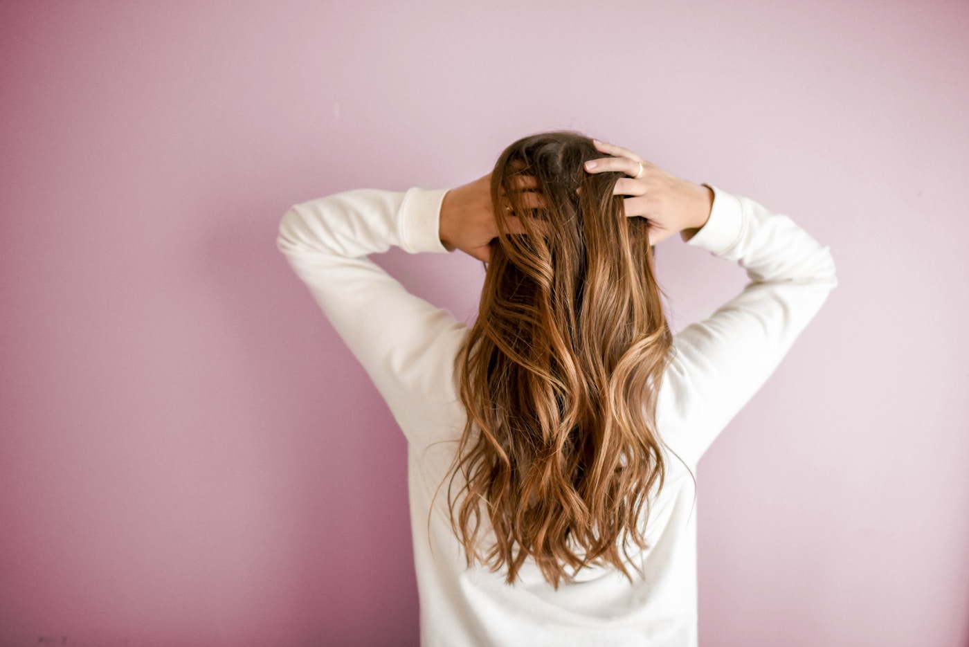 Woman looking down, soft light on hair and shoulders